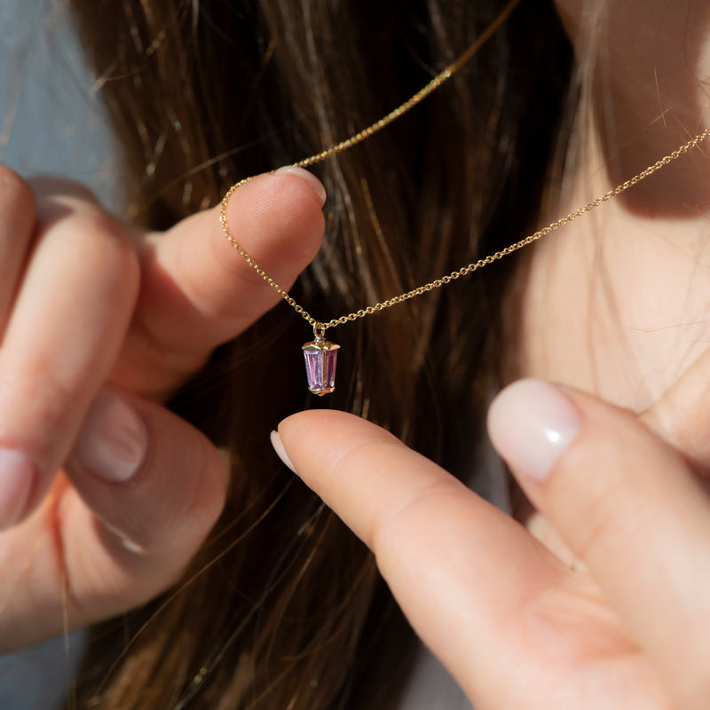 dainty-lilac-sapphire-lantern-pendant-in-solid-gold-on-finger