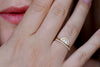 Dainty wedding ring with a tall front on hand